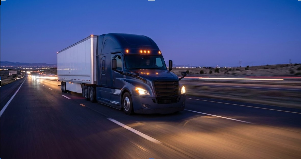 Modern Freightliner Cascadia tractor on an interstate corridor at twilight, representing same day and next day expedited freight